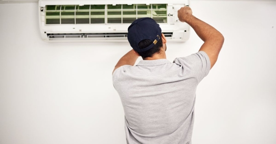 AC technician working on unit