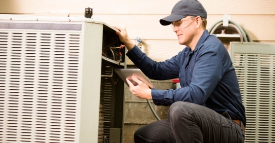 AC technician working on system