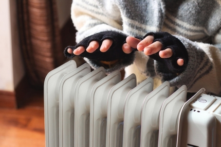 Person heating their hands at home