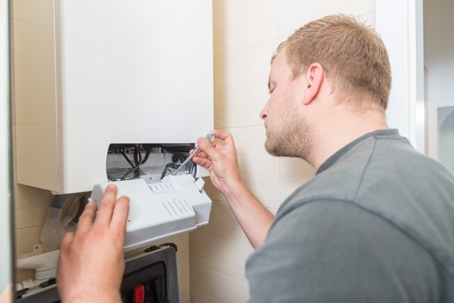 Technician installing a Gas Furnace