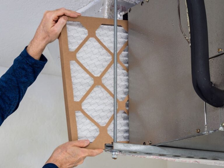 Close up of dusty, clogged air filter taken out of home air conditioner