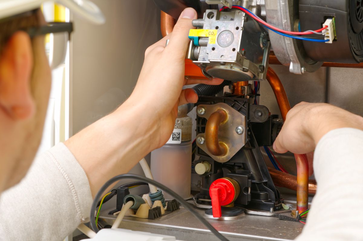 Maintenance and Repair of a gas boiler, setting up and servicing. Technician servicing the gas boiler for hot water and heating