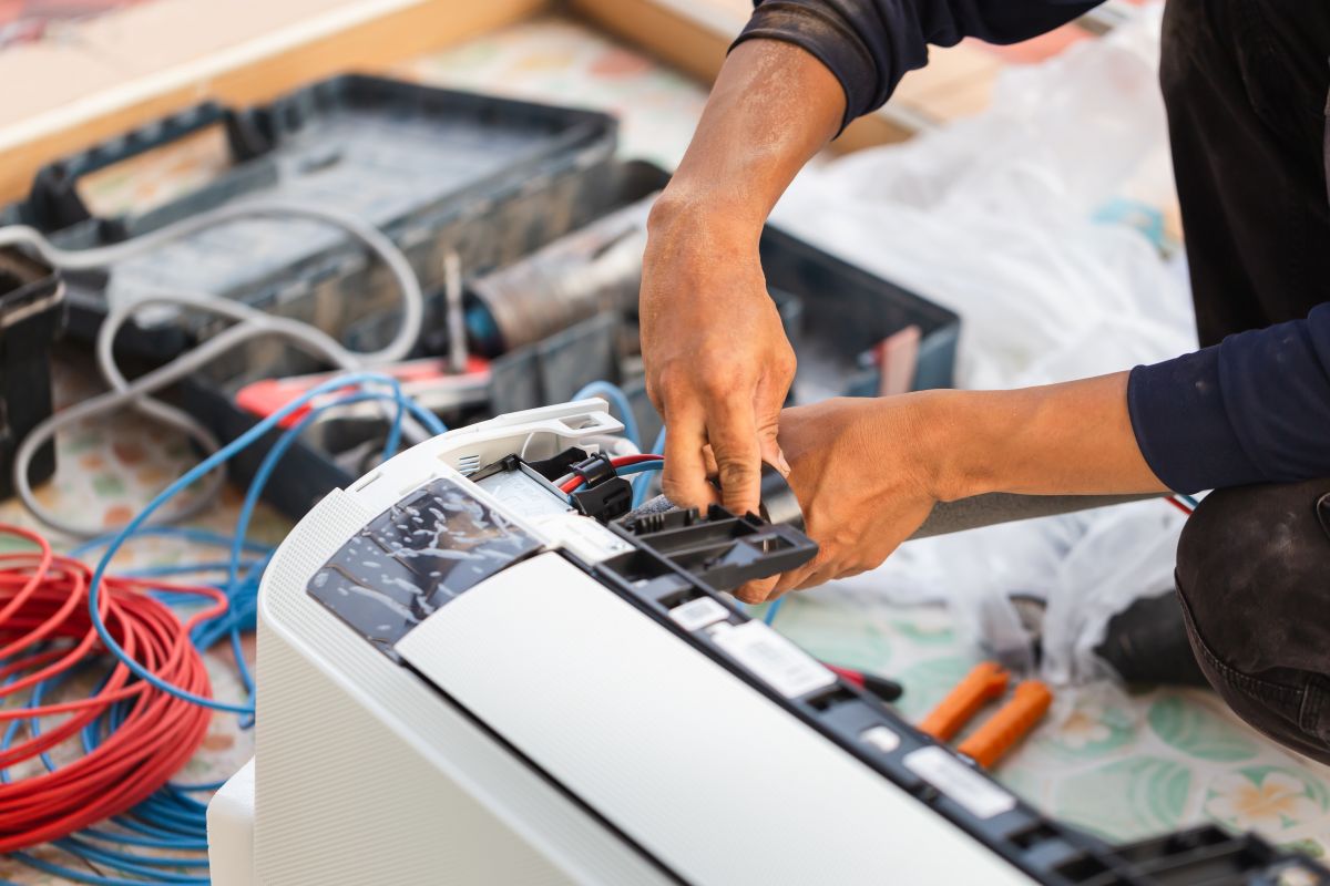 Repairman fix air conditioning systems