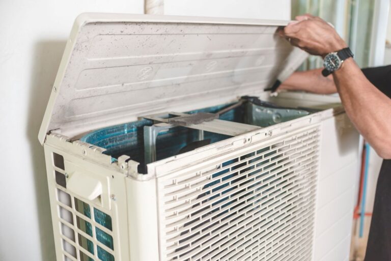 hands doing ac maintenance