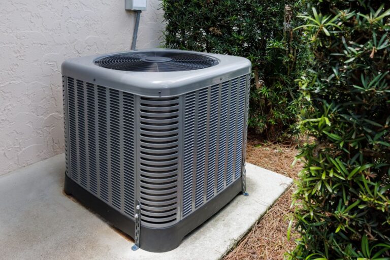 outdoor ac unit not turning on grey unit outside against white wall