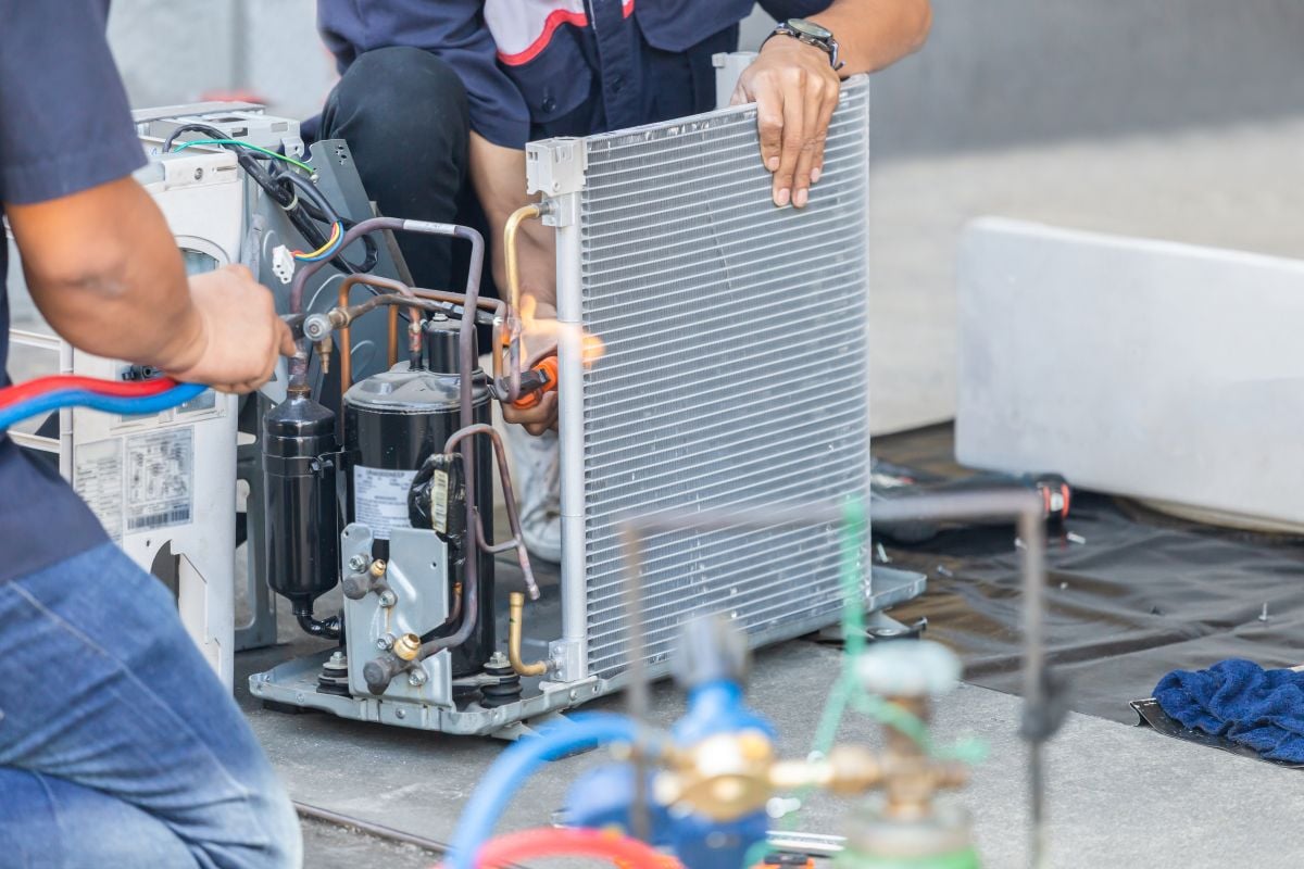 two workers ac installation