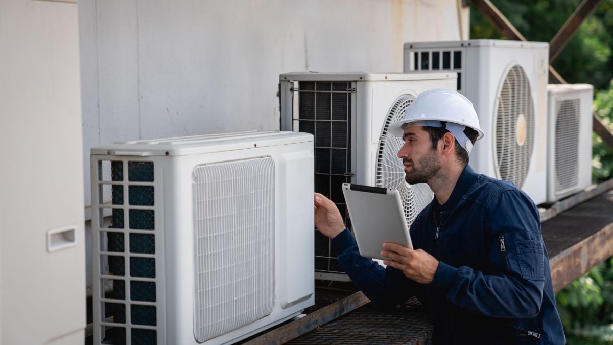worker checking ac functioning