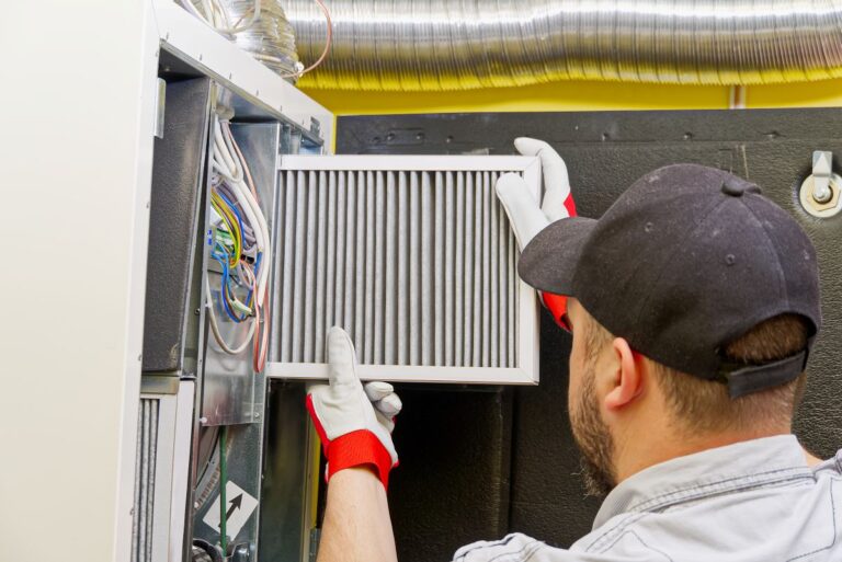 worker replacing furnace filter