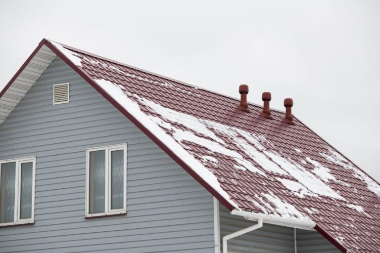 snow melting on a house with a tile roof