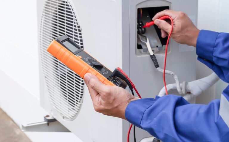 Air conditioner technician checking air conditioner operation