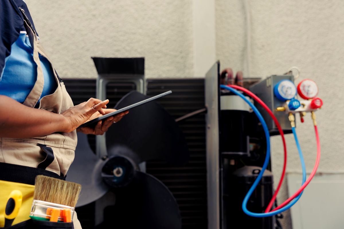 Certified technician commissioned for outside hvac system routine maintenance