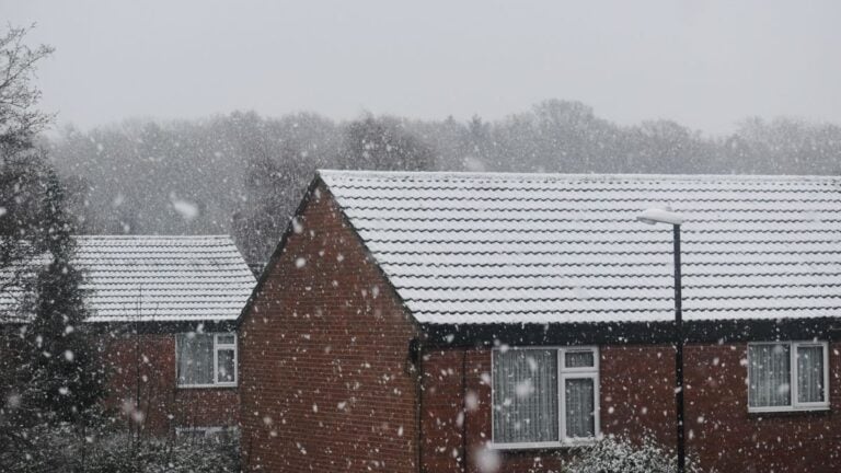Old brick houses in snow on a winter morning
