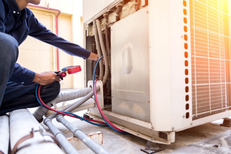 Technician is checking air conditioner, measuring equipment for filling air conditioners