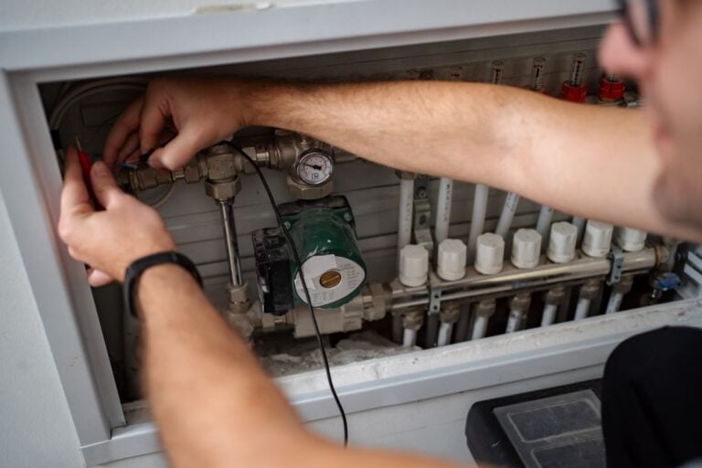 Technician working on home heating system maintenance