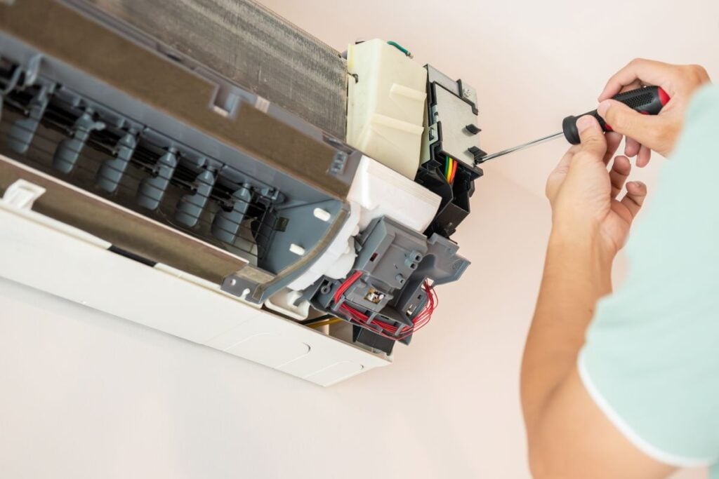 Electrician man repair and maintenance air conditioner