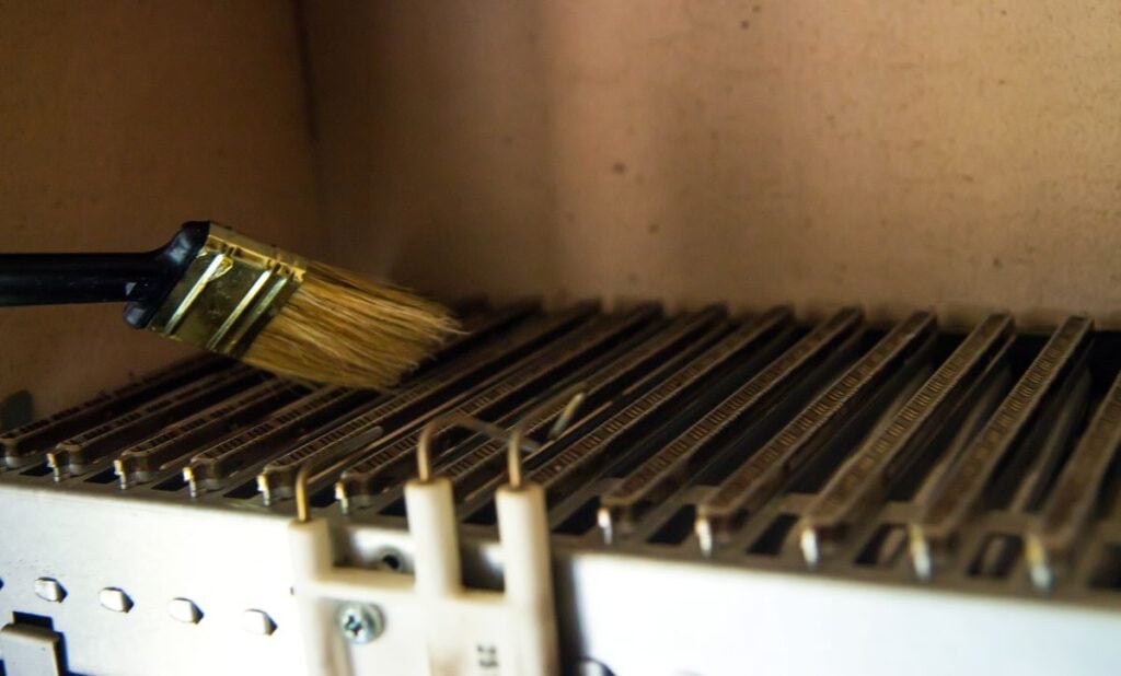 process of cleaning the heat exchanger of a gas boiler with a brush. prevention of failures